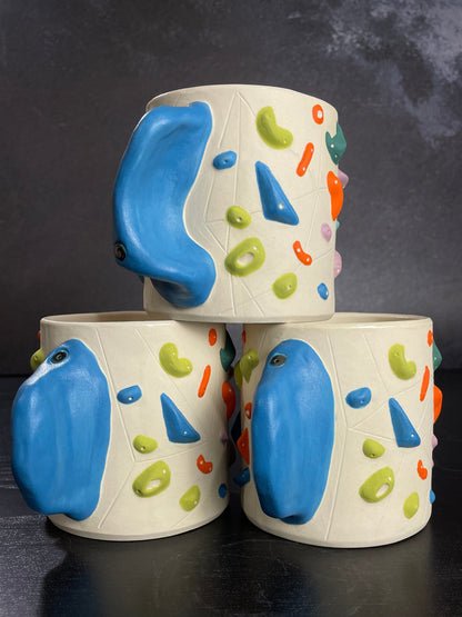 ceramic cup that mimics a climbing wall with a hold handle